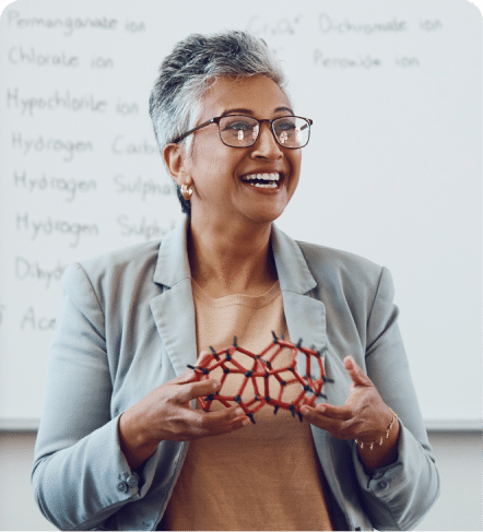 Smiling educator in front of a whiteboard