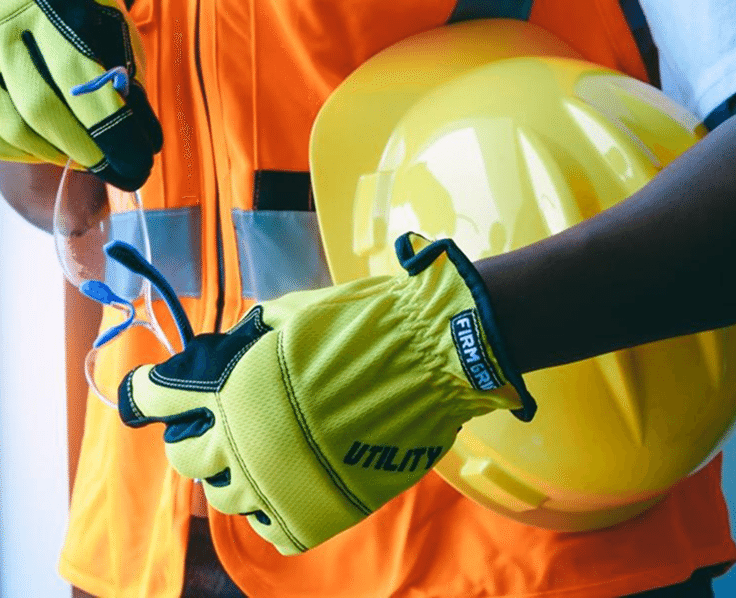 Worker in safety gear with hard hat and gloves
